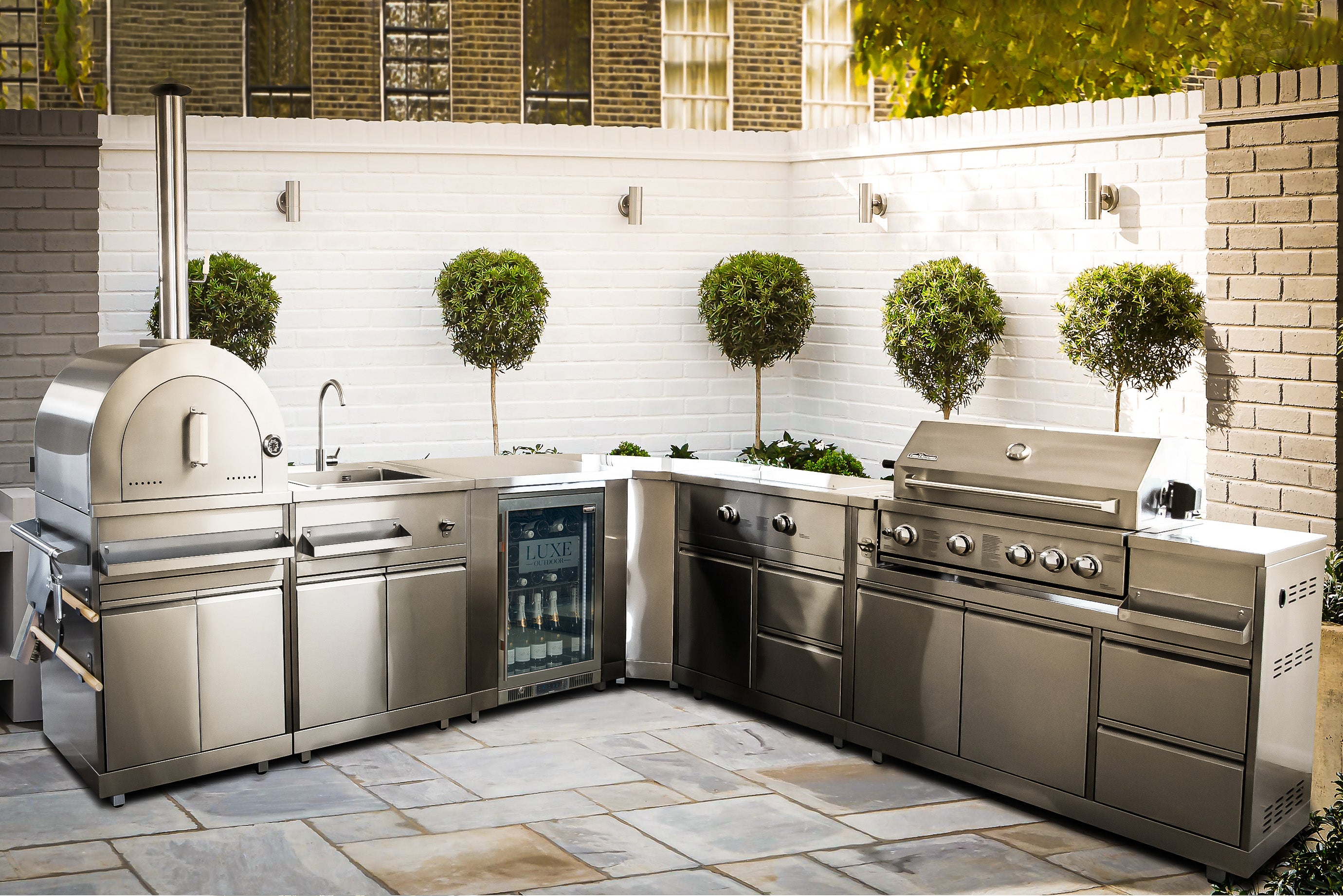 Front image of stainless steel luxury outdoor kitchen in a walled terrace
